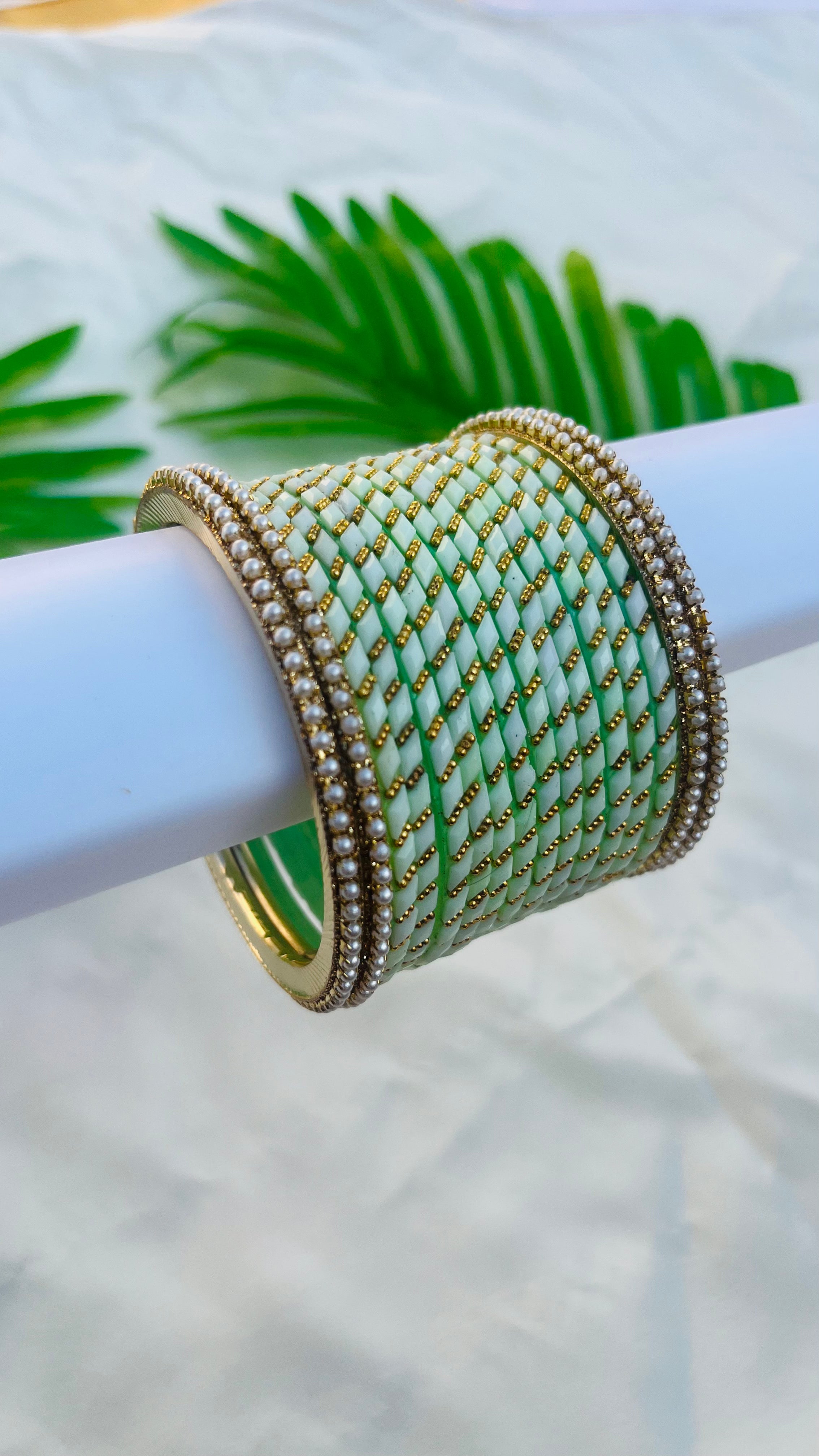 ANIKSHYA PISTA GREEN GLASS BANGLE AND WHITE PEARL METAL BANGLE VH050