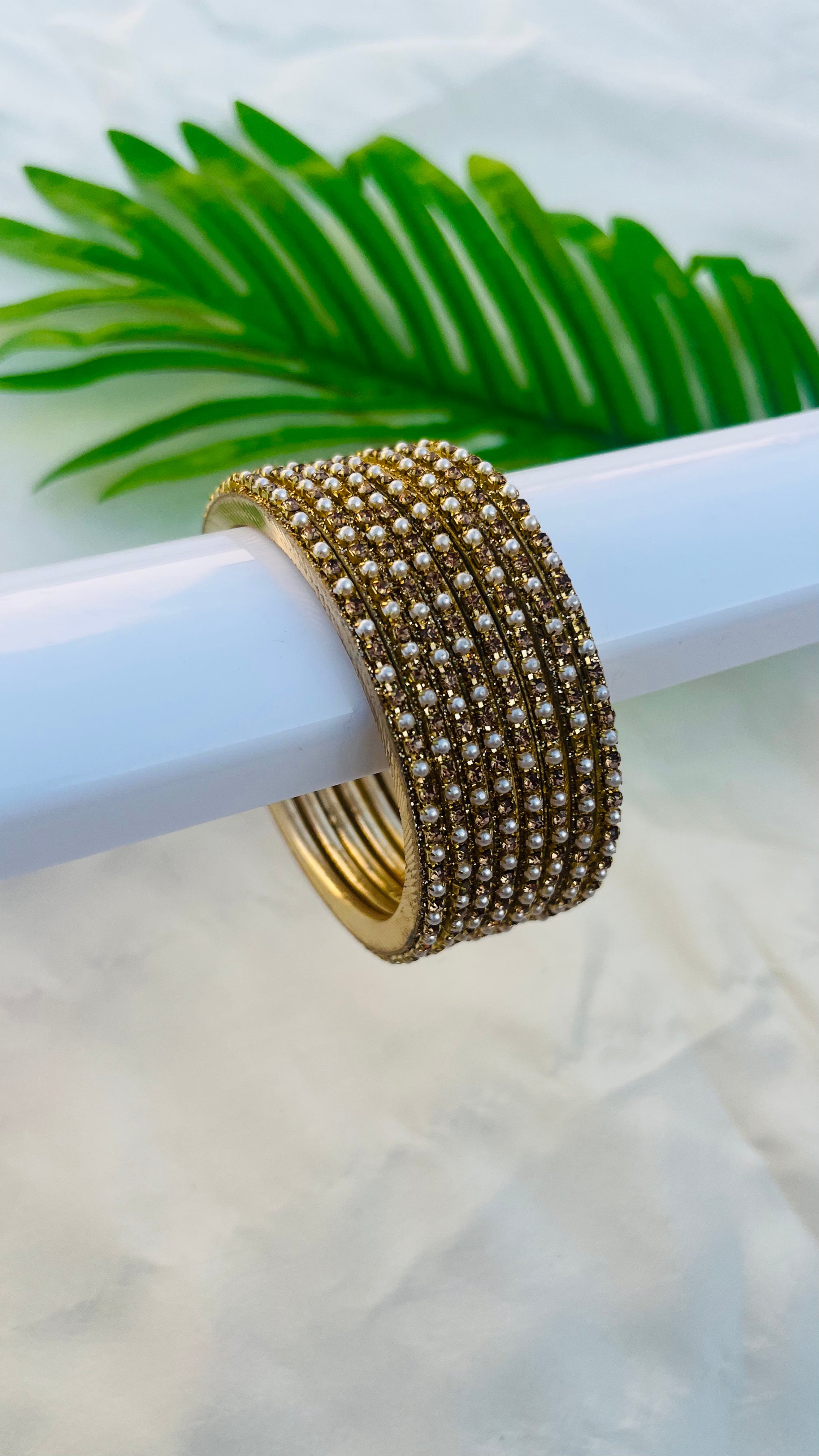ANIKSHYA GOLD STONE AND WHITE PEARL METAL BANGLE VH059