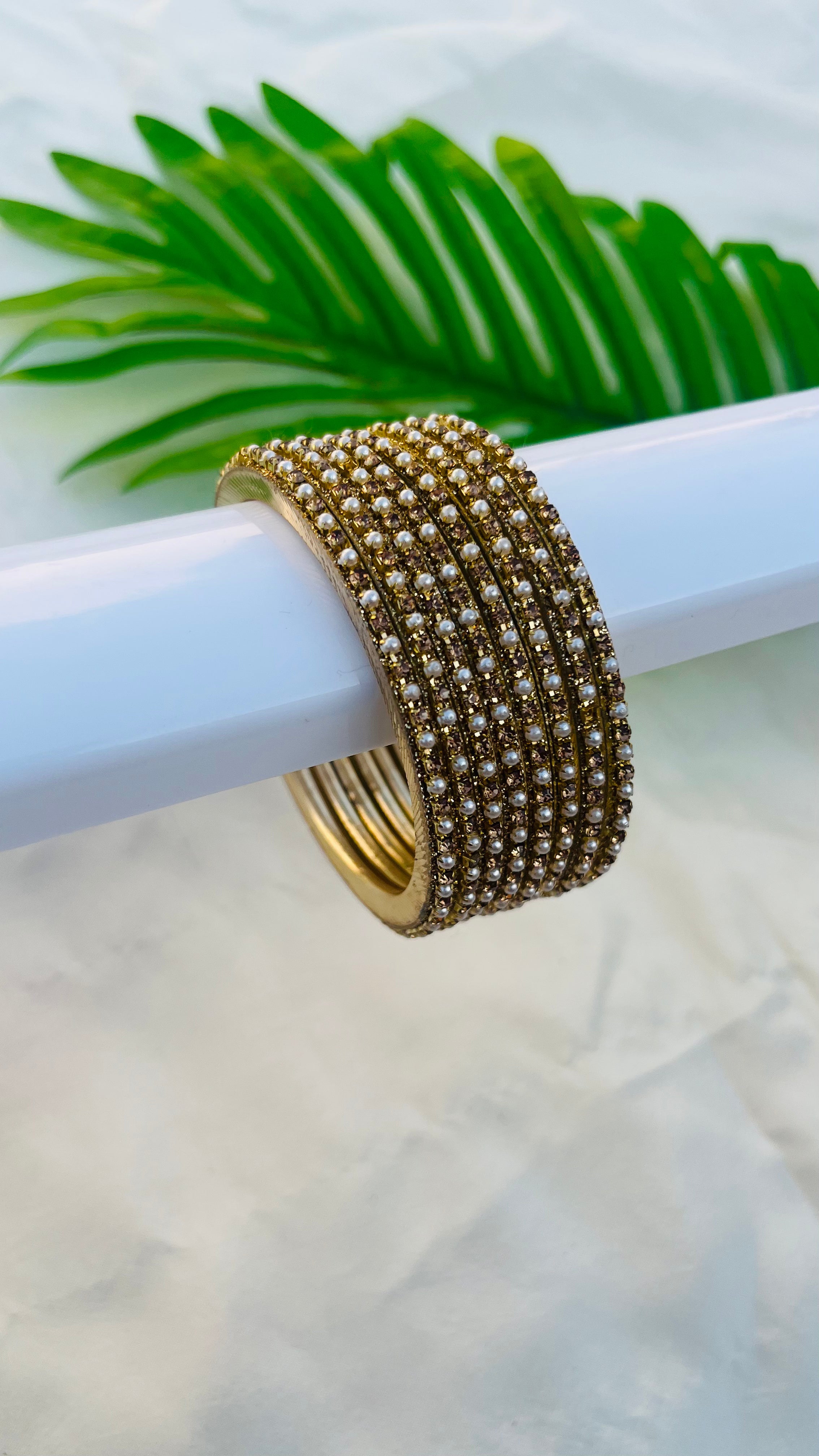 ANIKSHYA GOLD STONE AND WHITE PEARL METAL BANGLE VH059