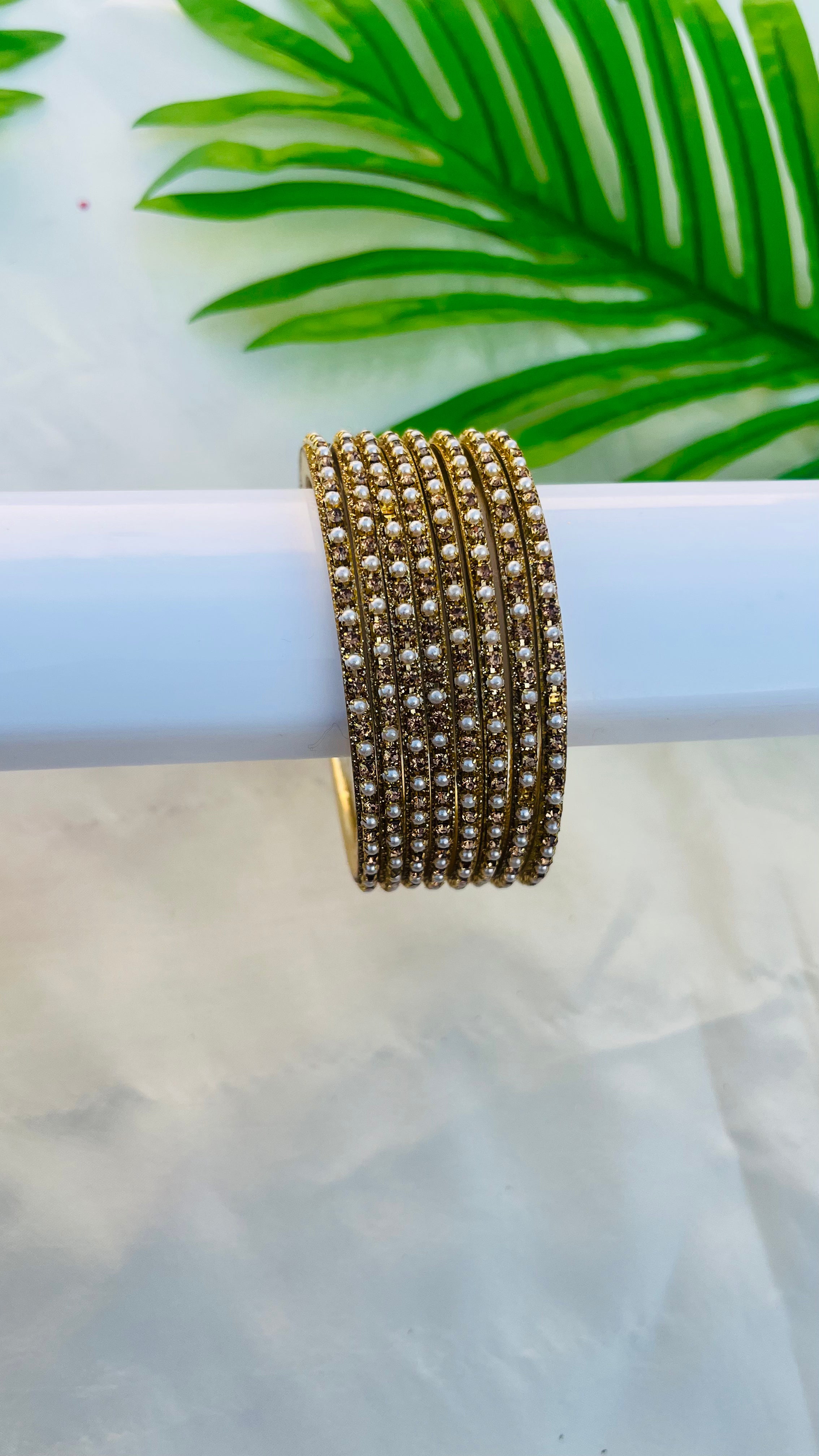 ANIKSHYA GOLD STONE AND WHITE PEARL METAL BANGLE VH059