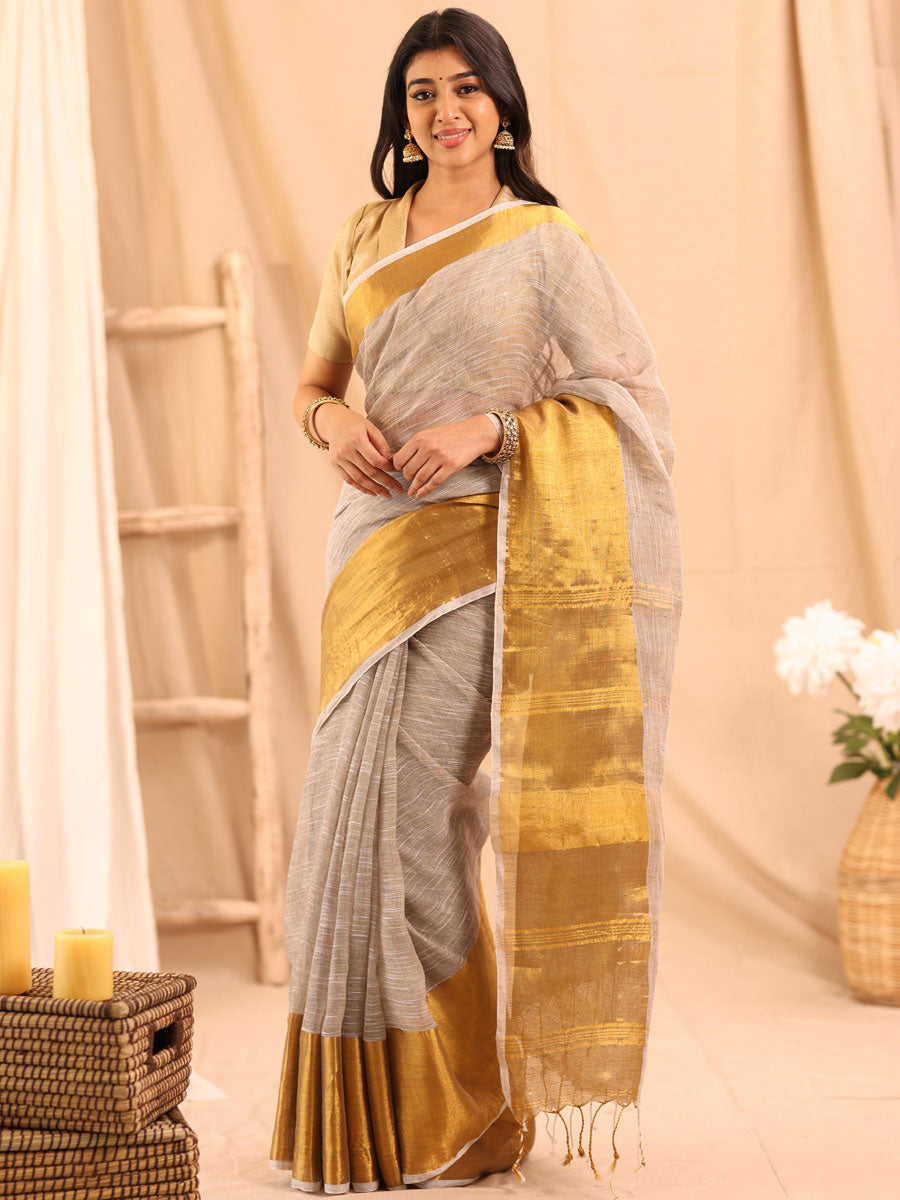 Anikshya Beige Linen saree with Antique gold Border