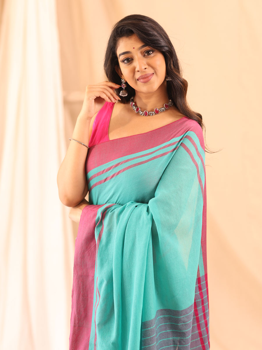 Anikshya Mul Turquoise with Pink Border saree