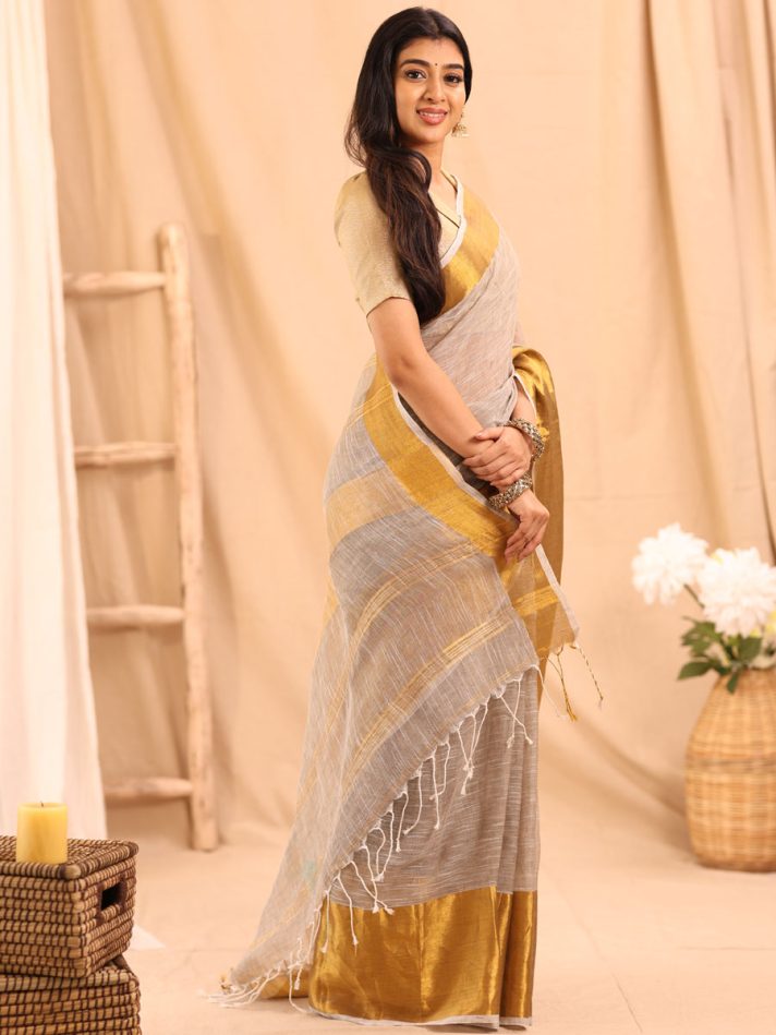 Anikshya Beige Linen saree with Antique gold Border