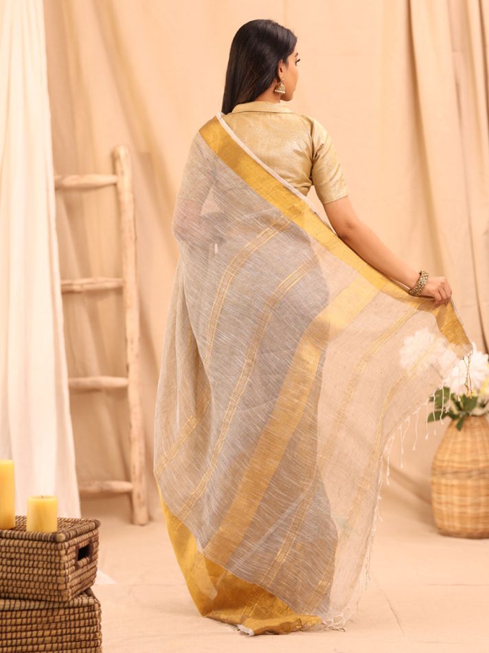 Anikshya Beige Linen saree with Antique gold Border