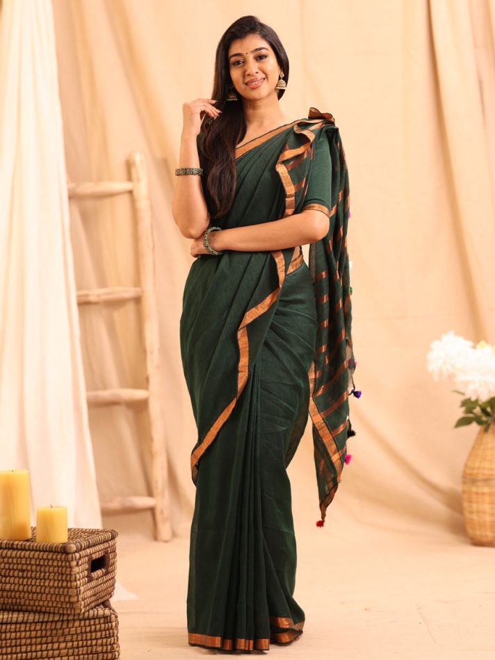 Anikshya Bottle Green Linen saree with Copper Gold Border