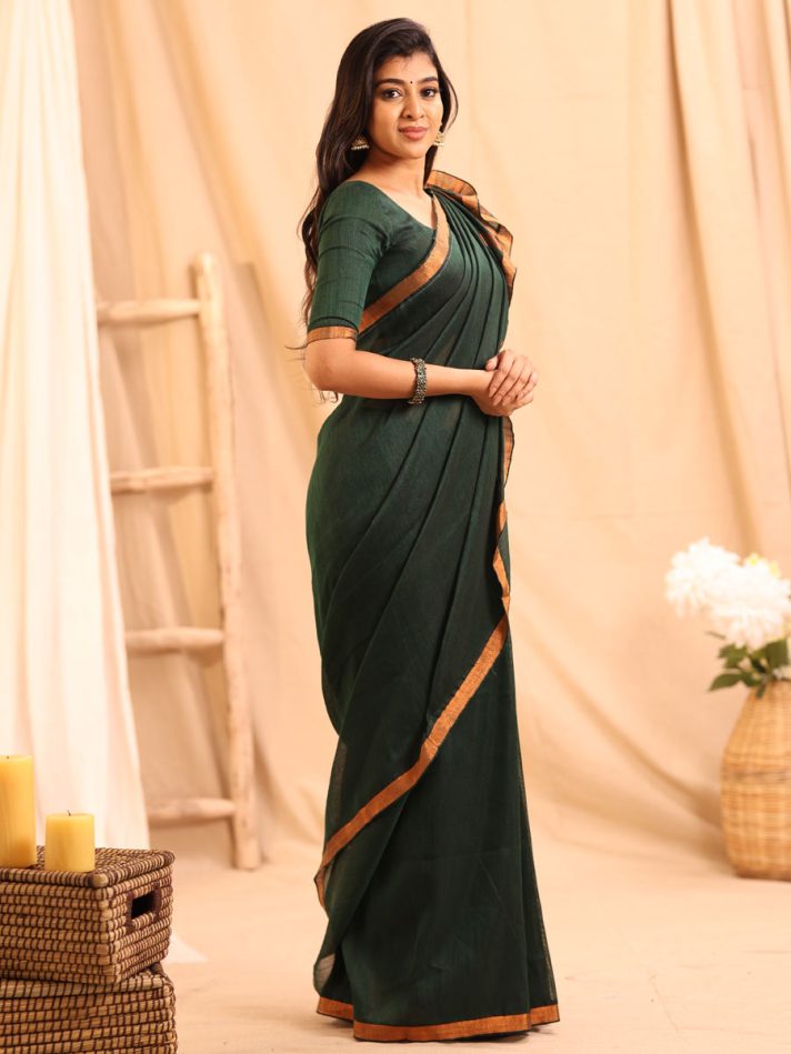 Anikshya Bottle Green Linen saree with Copper Gold Border