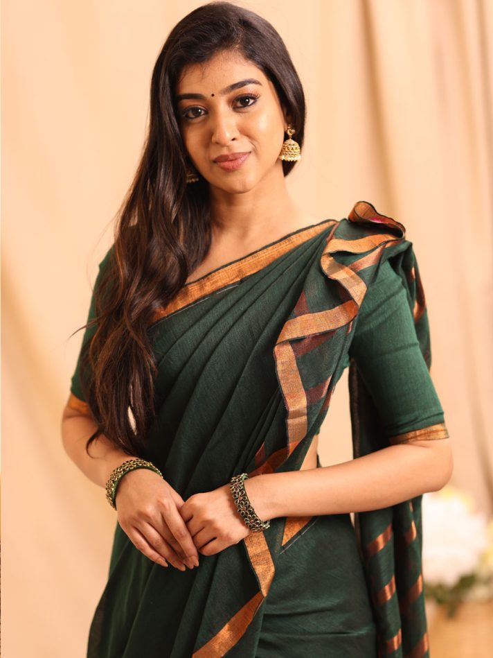 Anikshya Bottle Green Linen saree with Copper Gold Border