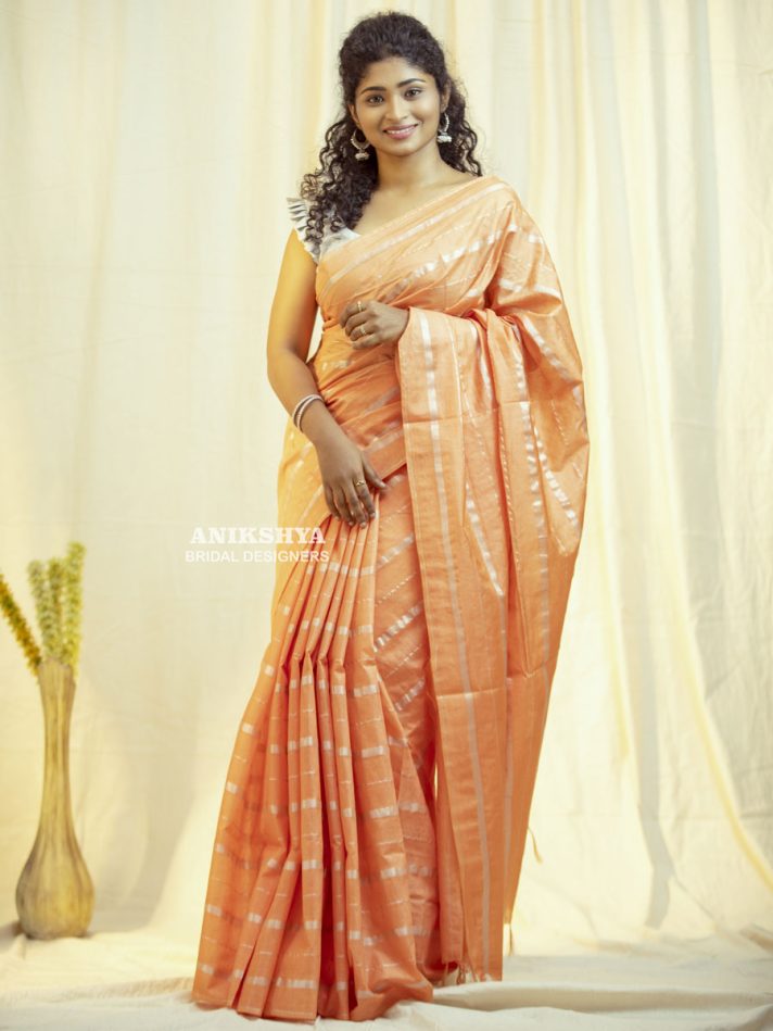 Anikshya Peach Kota Viscose Silk saree with silver stripes